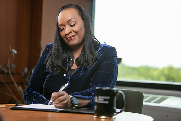Dr. Green writing at her desk