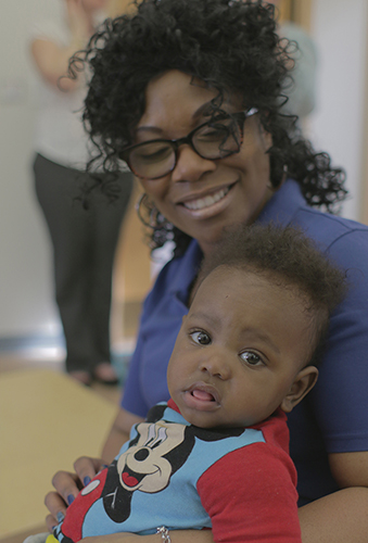 FDC staff member holding child