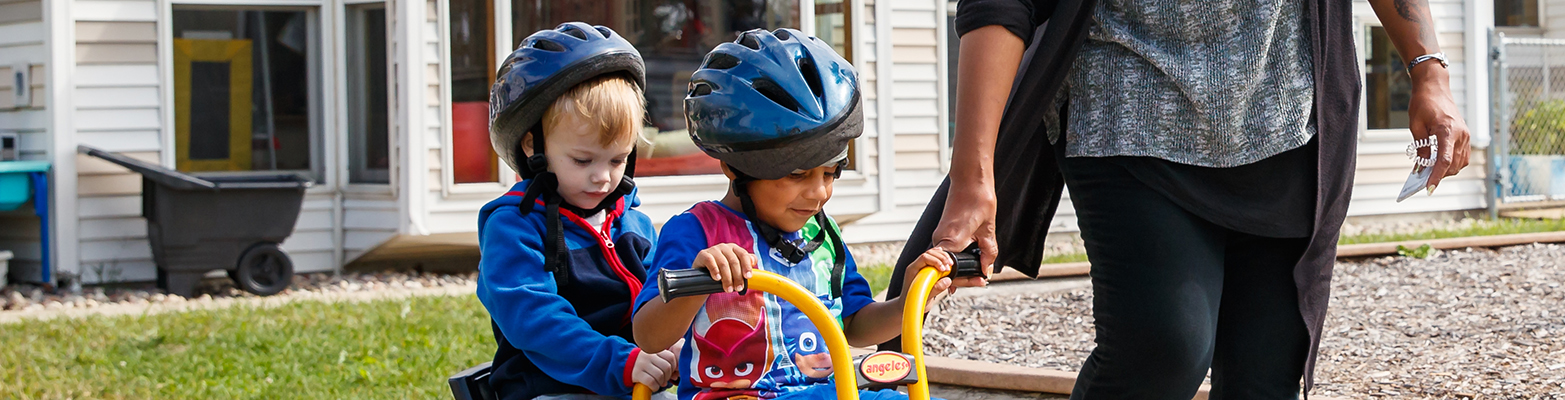 Children riding tricycle