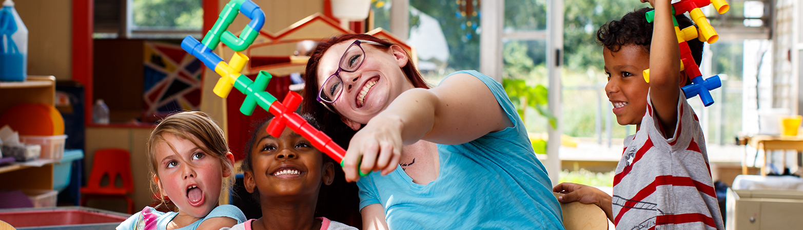 FDC staff member playing with children