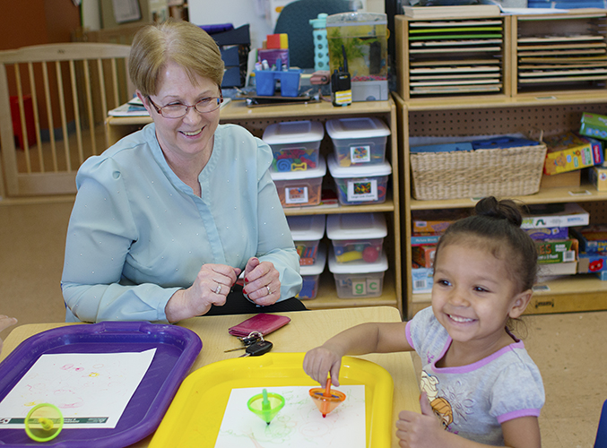 FDC staff member with child