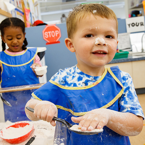 Children scooping flour
