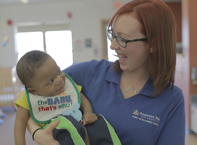 Child and FDC staff member smiling at each other