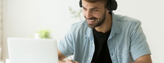 Male student looking at laptop screen