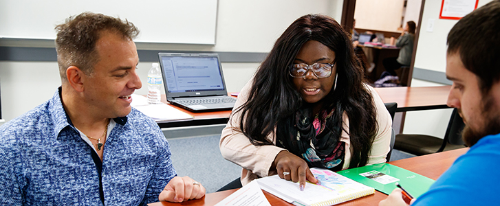 Professor helping students with classwork