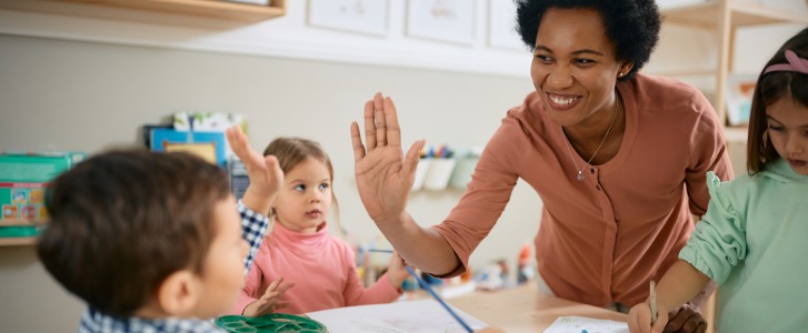 Teacher high-fiving student