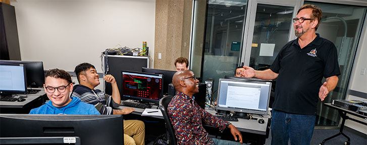 Happy Class of Cybersecurity Students with Instructor Steve Hyzny Happy Class of Cybersecurity Students with Instructor Steve Hyzny