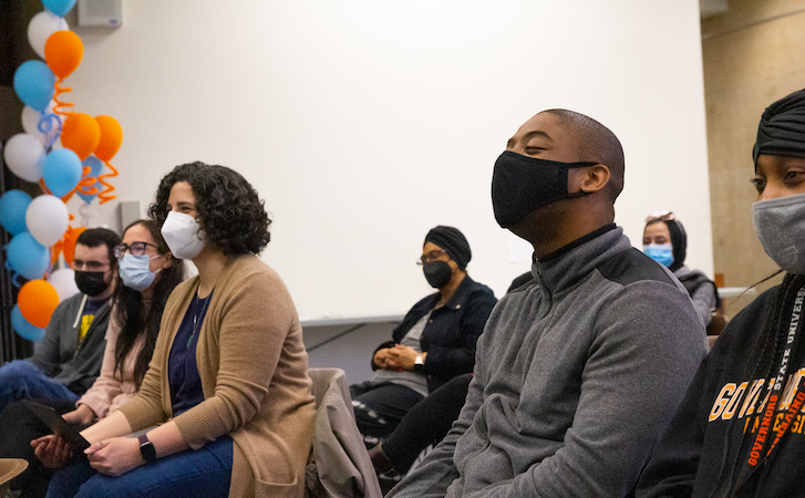 Audience members watching poetry slam