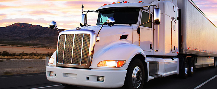 Semi truck driving on desert road