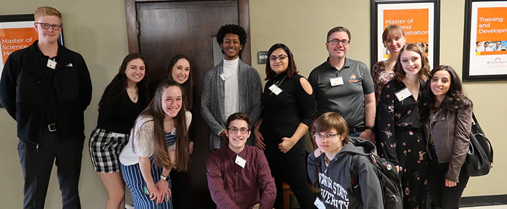 Honors students grouped together for picture with Dr. Rhea