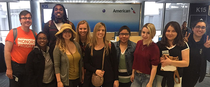 Honors College members posing for photo at airport during Rome trip
