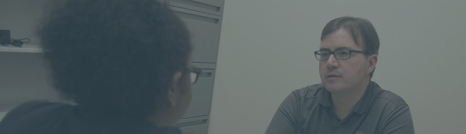 Dr. David Rhea talking with a student in his office