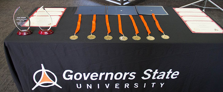 Honors medals, certificates, and trophies on table