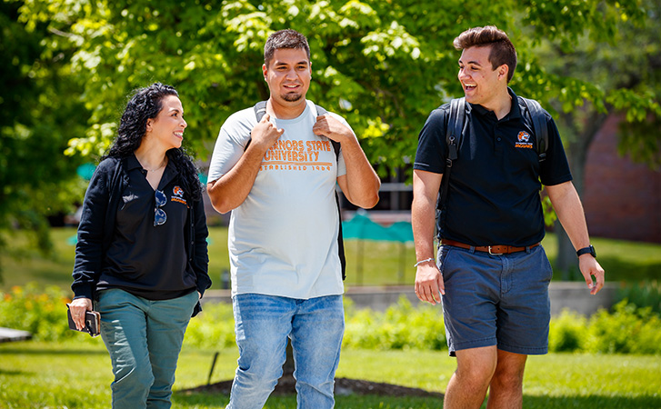 Students walking and talking with admissions staff