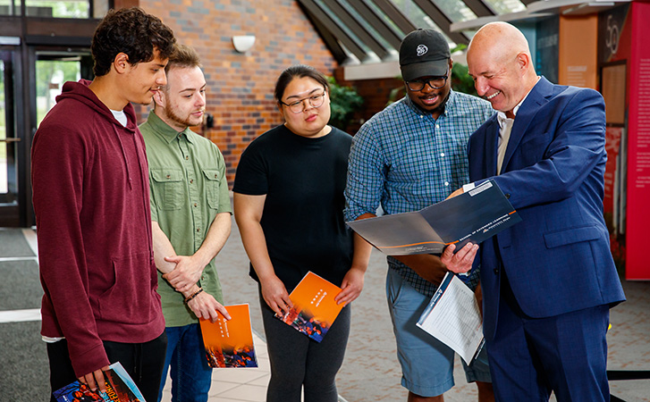 Admissions staff member giving transfer students a campus tour