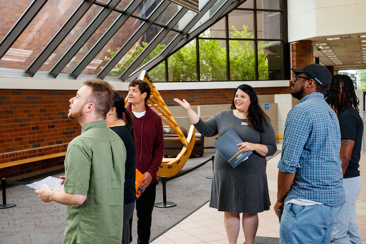 Admissions team member giving students a campus tour