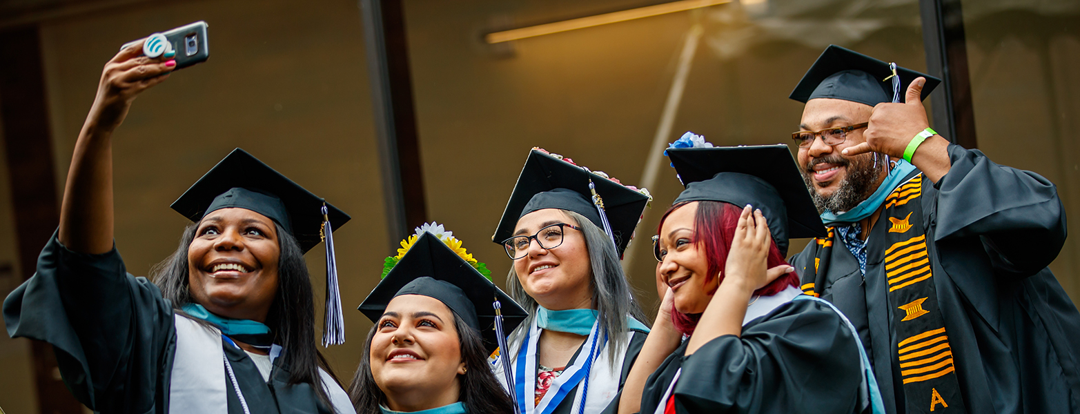 5 happy graduates taking a "selfie"