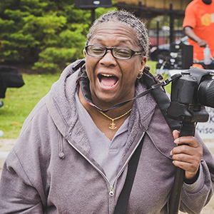 Levilyn Chriss laughing while holding film camera