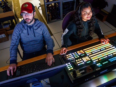 Students working with soundboard in media studio room