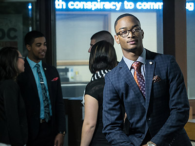 business student in front of electronic ticker 