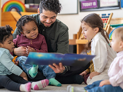 Minority Teacher reading to students