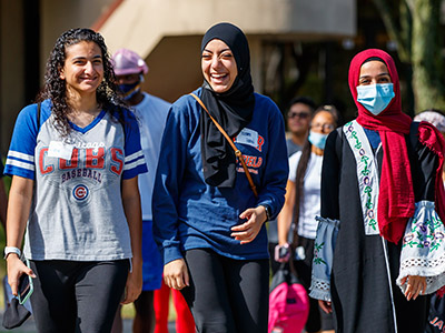 3 happy students on campus