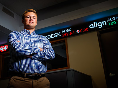 business student in front of tickertape