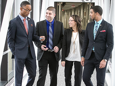 Business students on the bridge to the G building