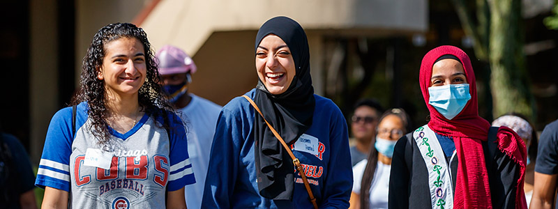 three students on campus