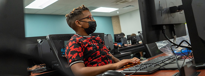 student with mask in computer lab