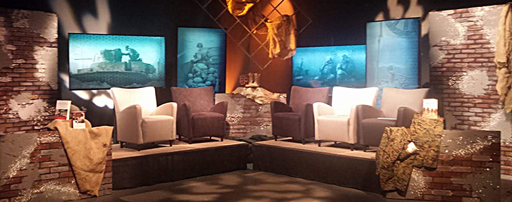 A room with chairs and TV screens