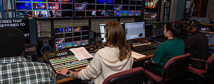 People sitting at a desk in a studio