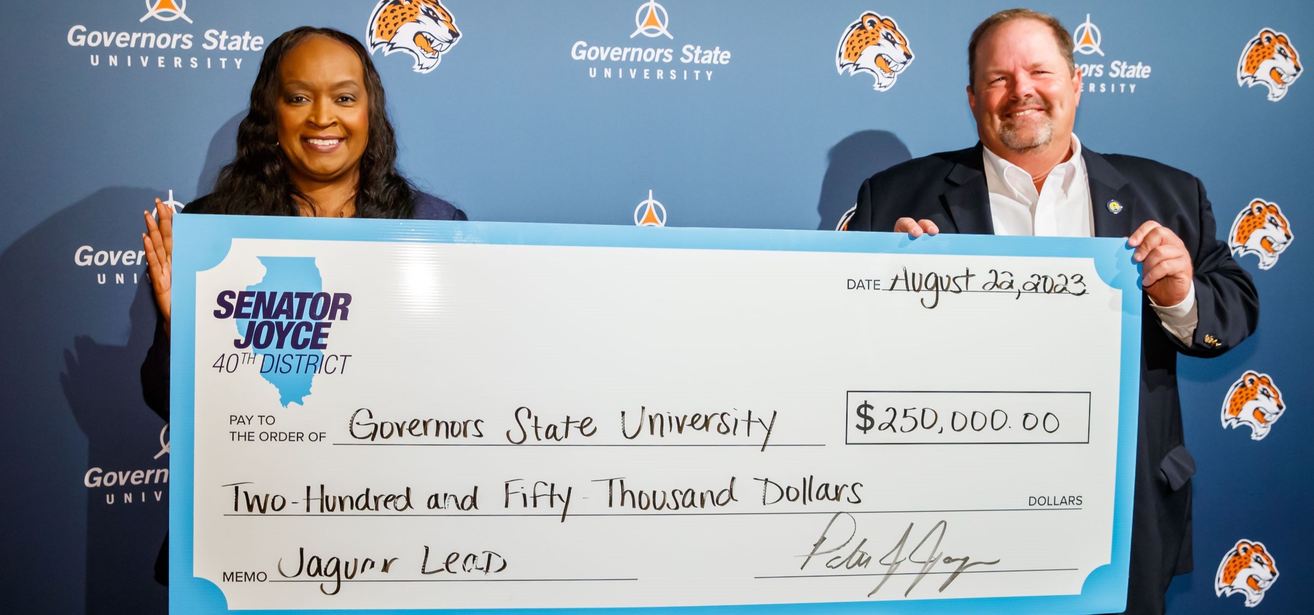 President Green and Patrick Joyce holding giant check