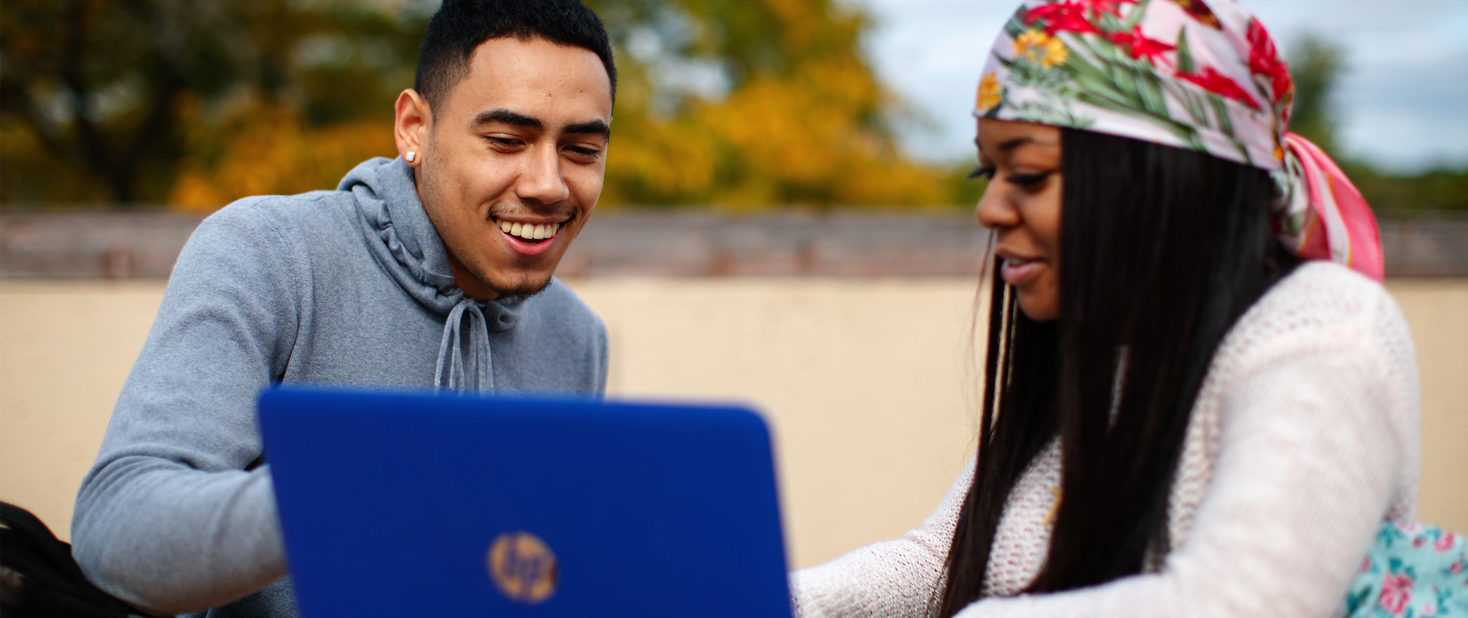 Students looking at laptop