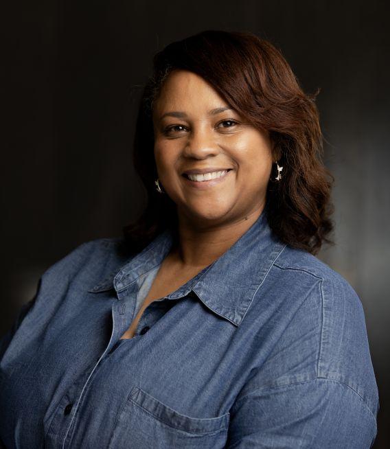 Woman with medium-long hair, wearing denim shirt