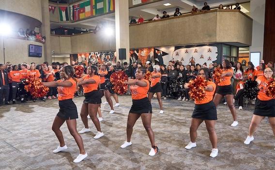 GovState cheerleading team with pom-poms at Homecoming Pep Rally