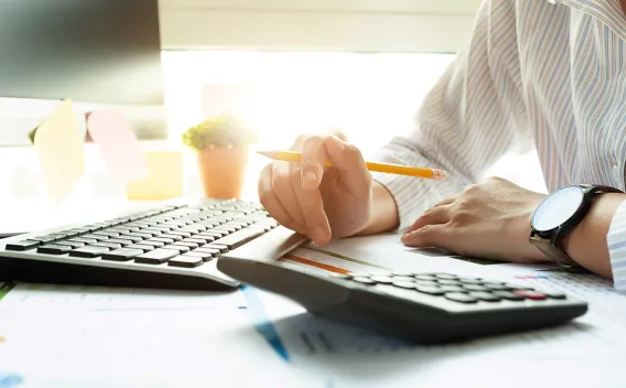 bookkeeper with calculator and computer keyboard