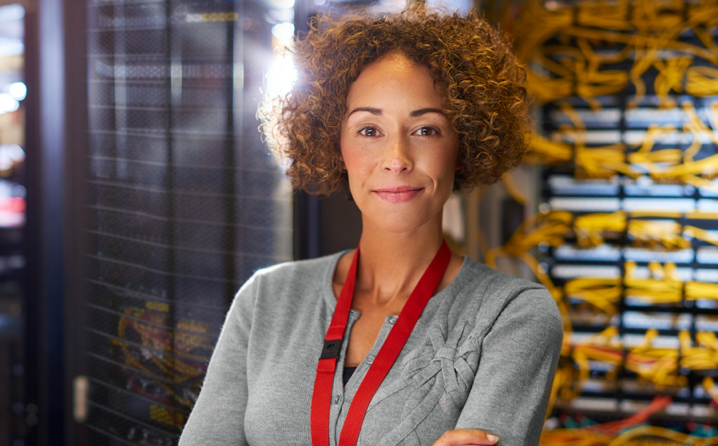Woman standing in front of server racks