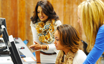 Three women looking at computer screens