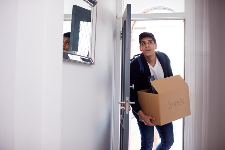 Male student moving into their new apartment